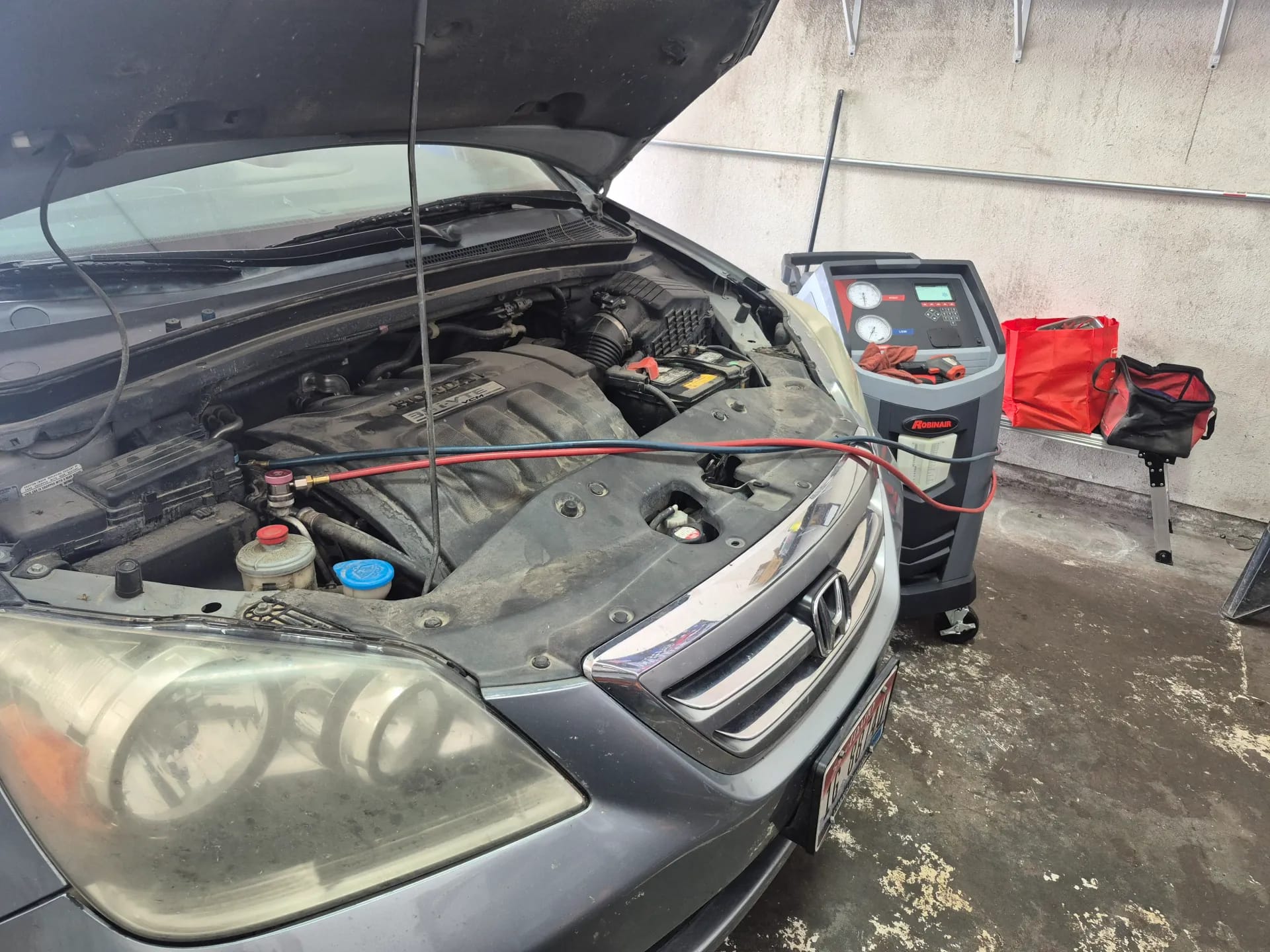 auto ac refrigerant service on acura engine bay