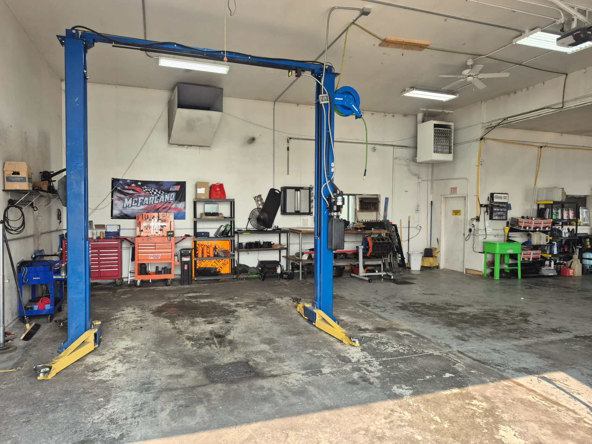 auto repair shop service bay with two post vehicle lift