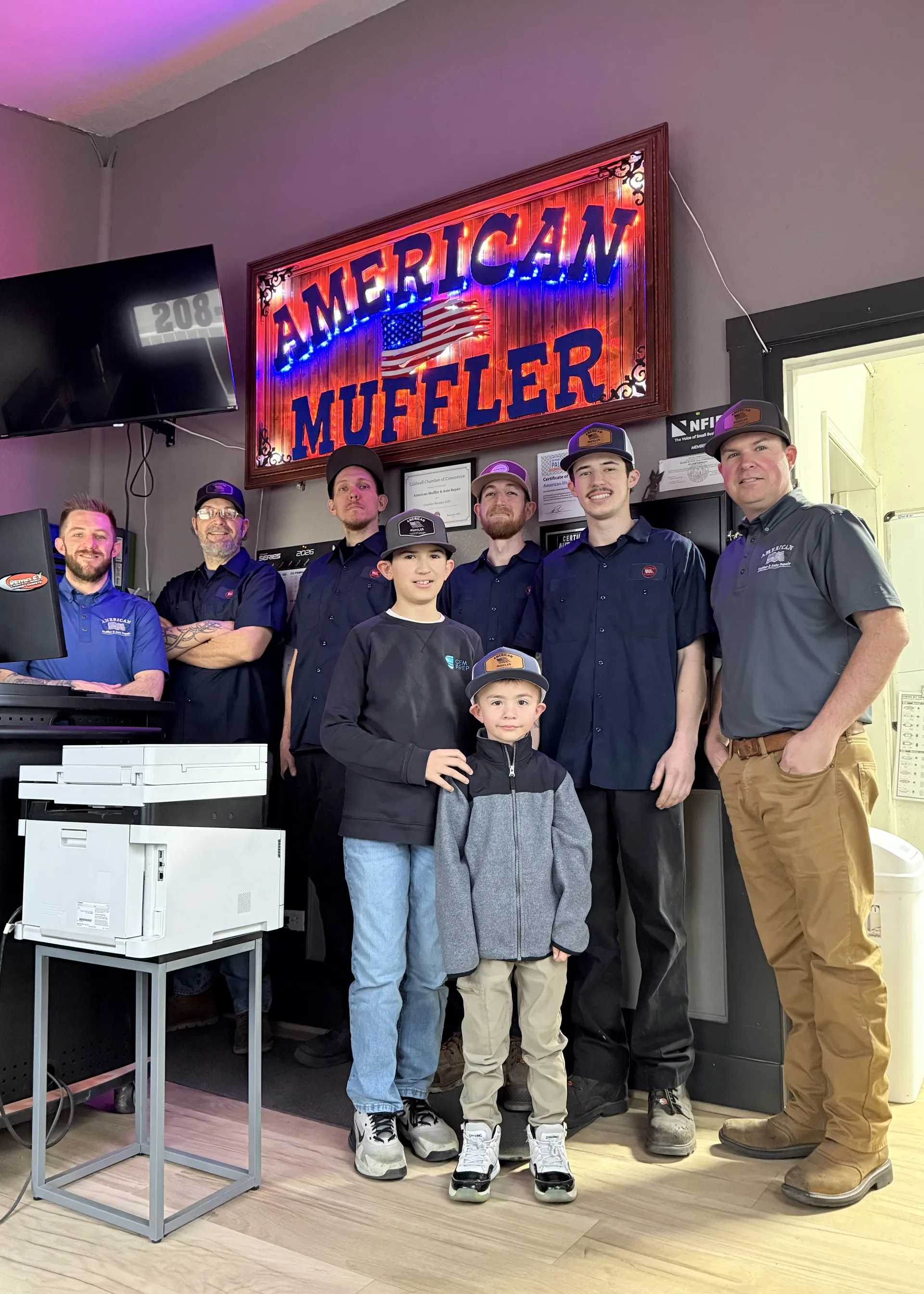 auto repair team inside shop american muffler