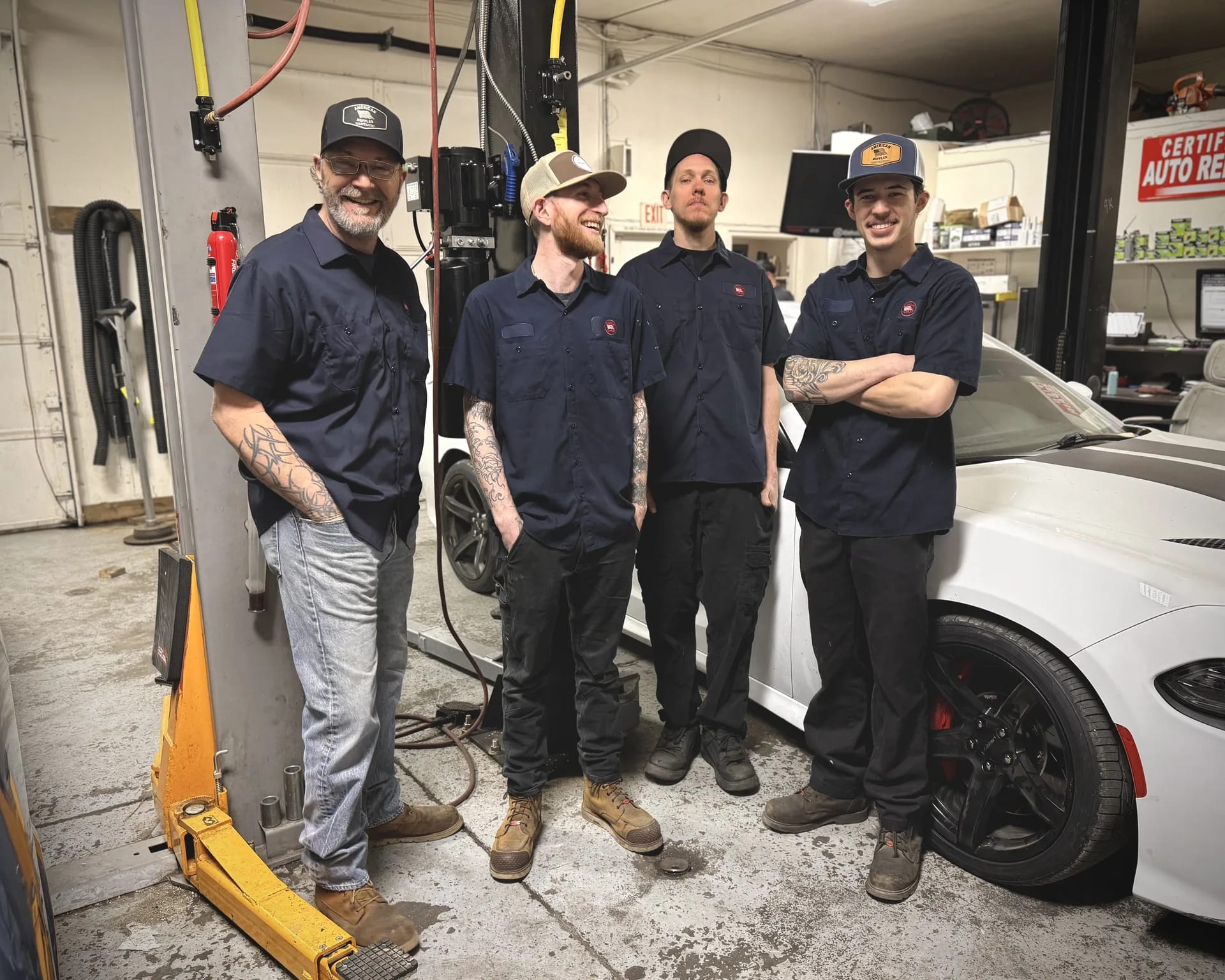 auto repair technicians working on vehicle in shop