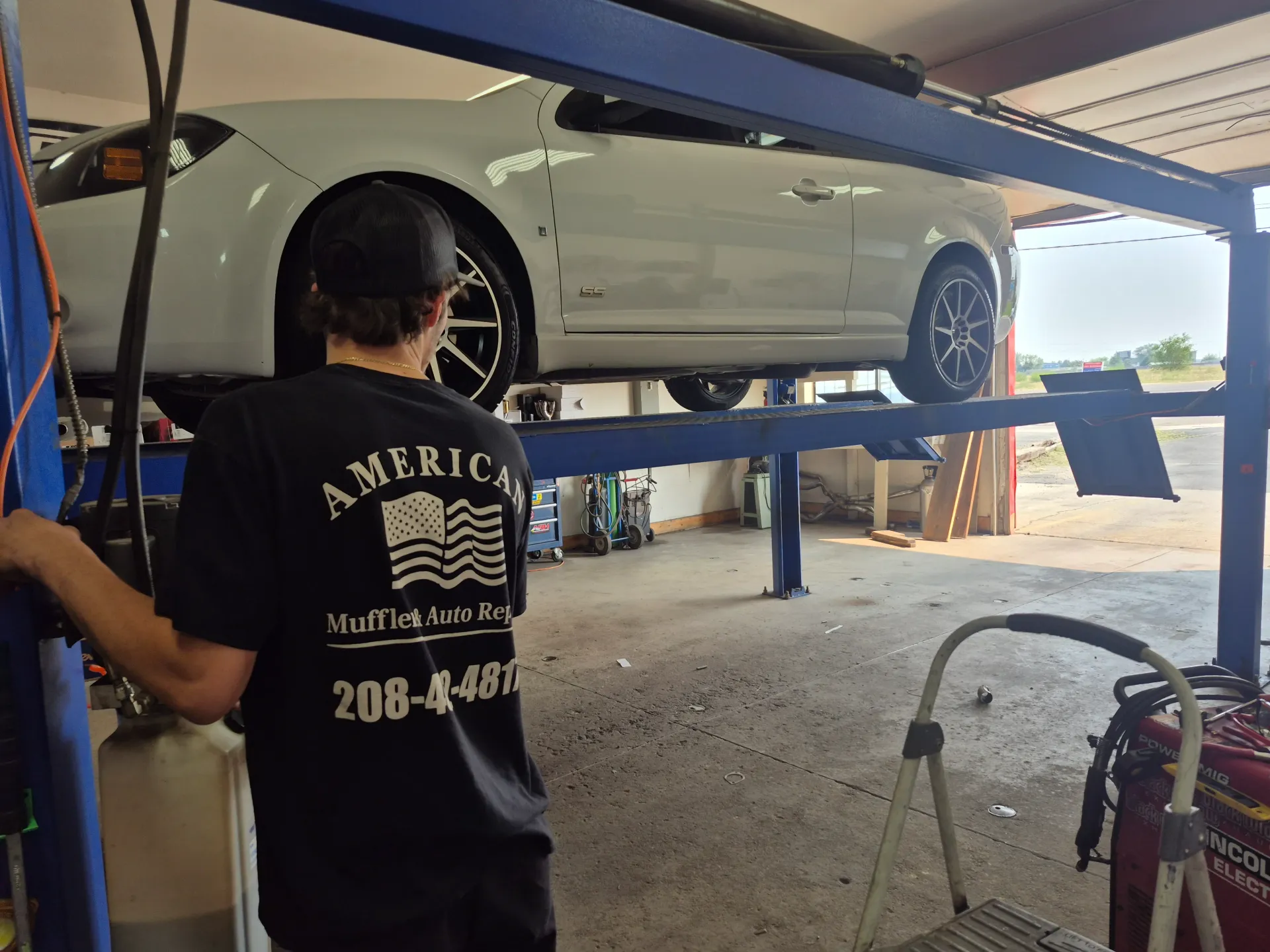car on two post lift for brake and undercar repair
