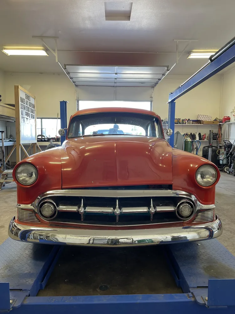 classic car on lift with brake suspension and exhaust services