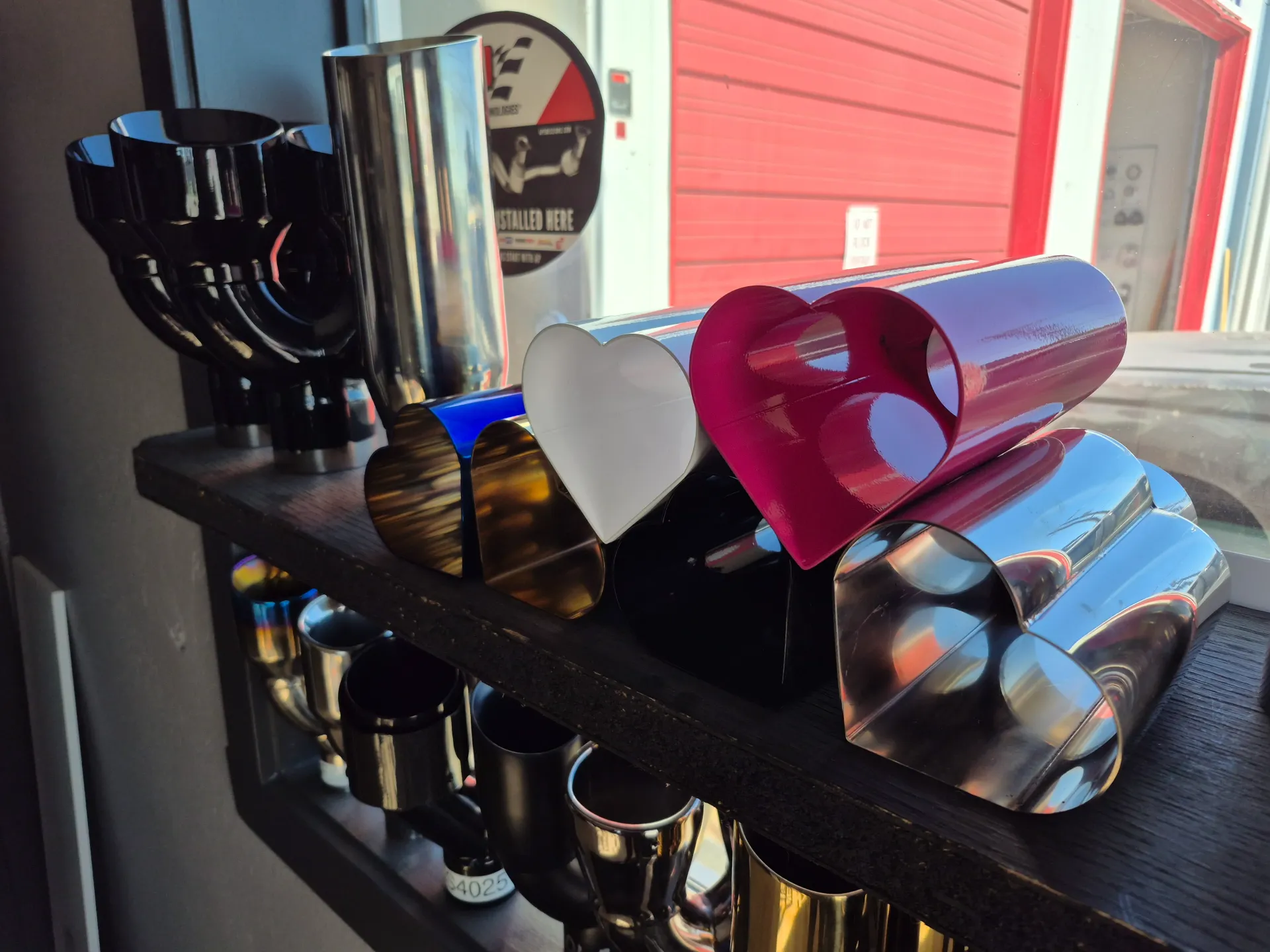 custom exhaust tips on display in muffler shop
