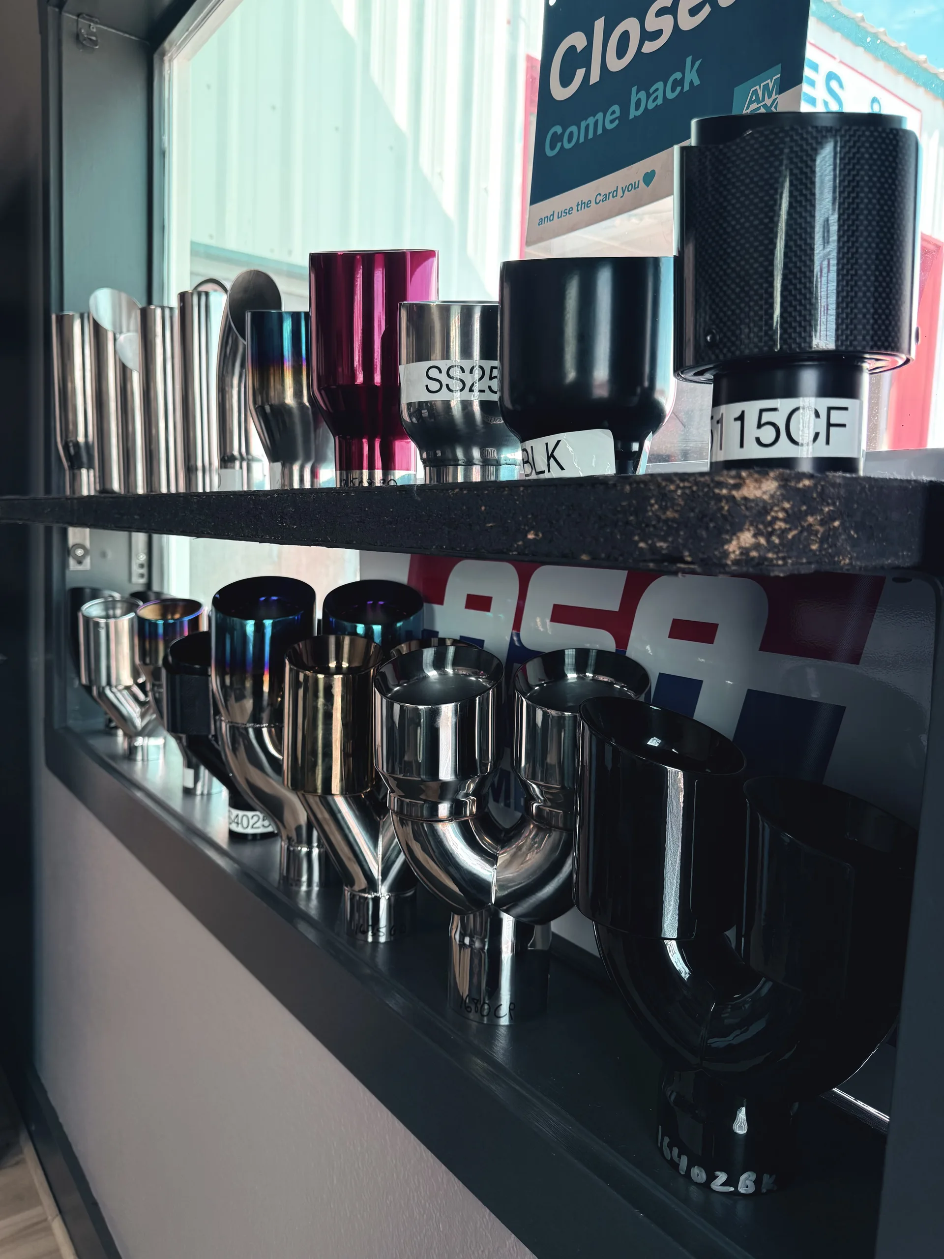 custom exhaust tips showroom display inside muffler shop