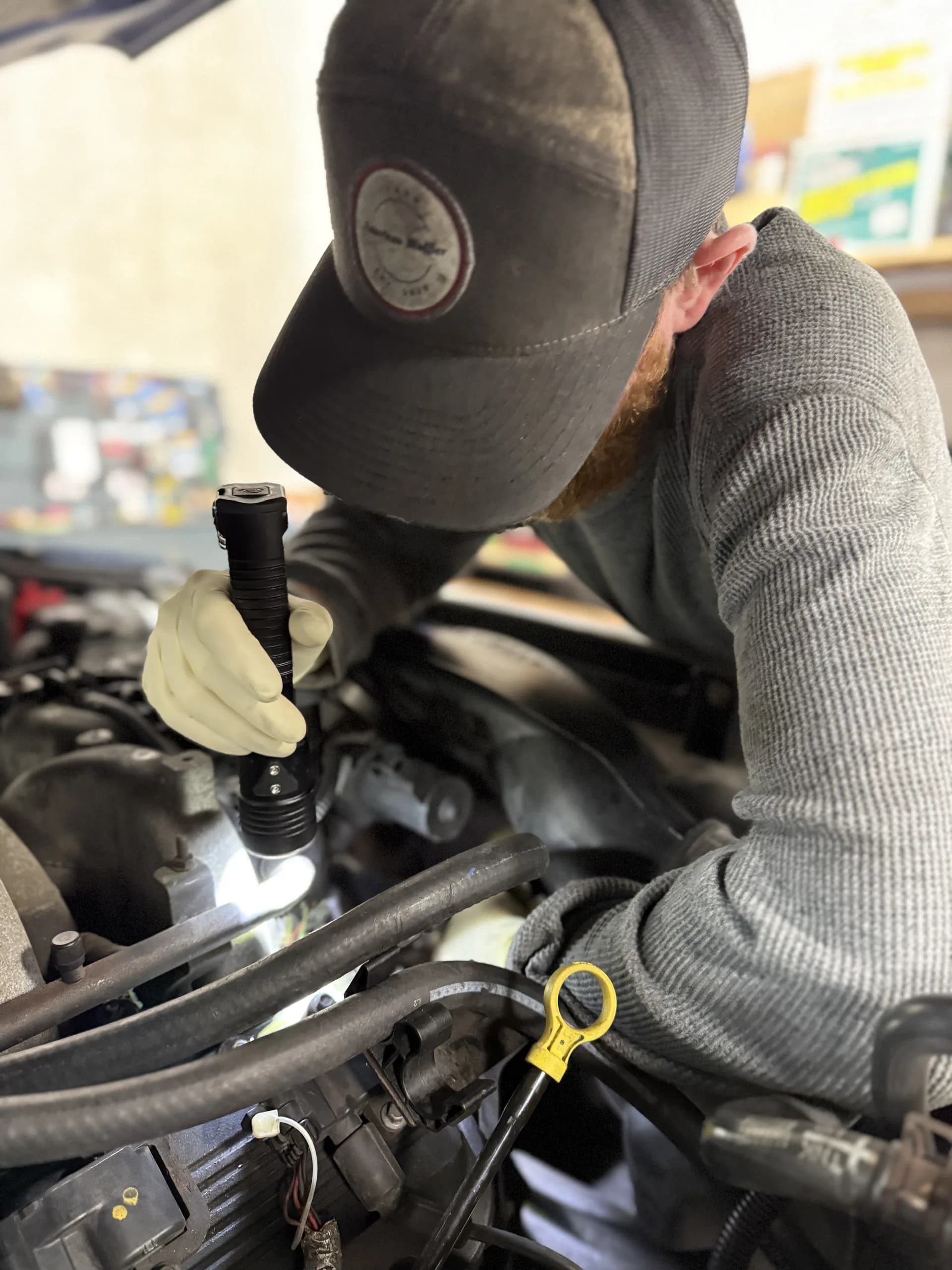 engine diagnostic inspection with flashlight auto repair technician
