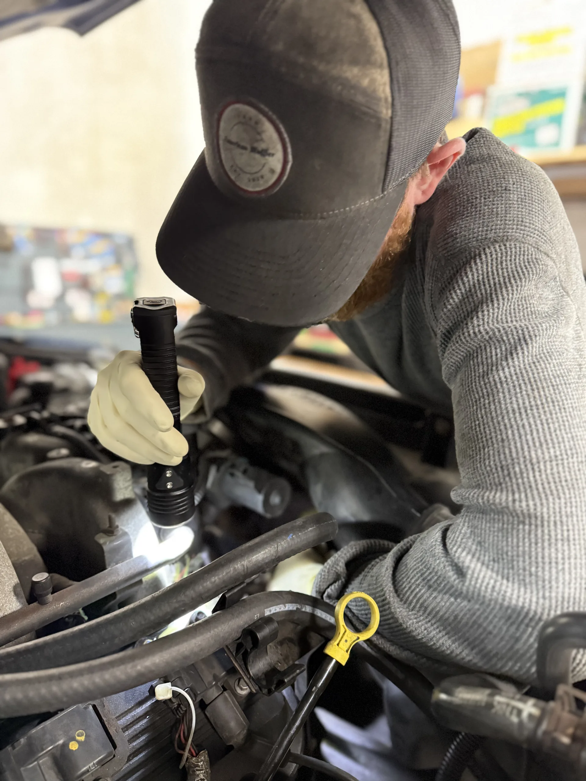engine diagnostic inspection with flashlight auto repair technician