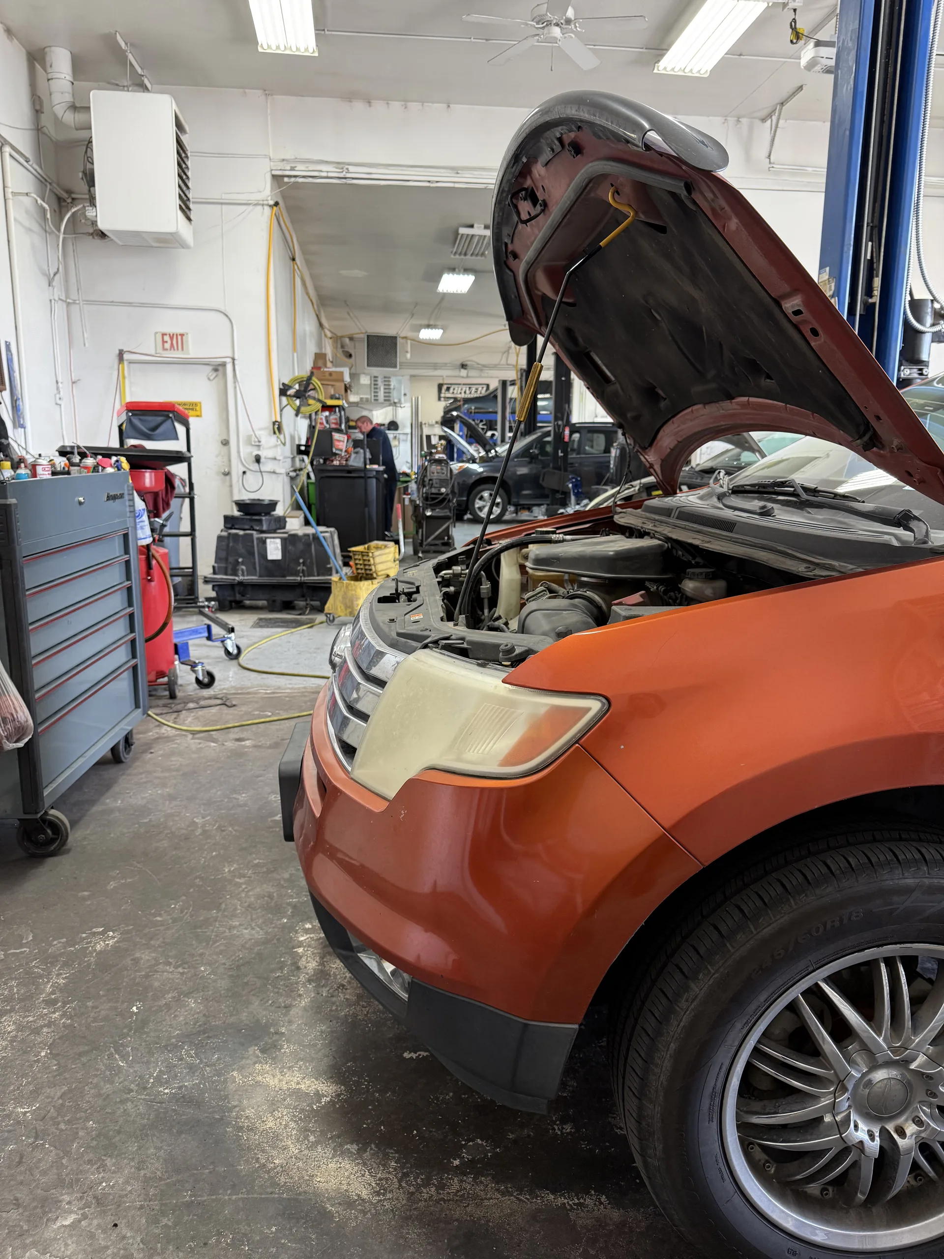 engine diagnostics and maintenance on suv in repair bay