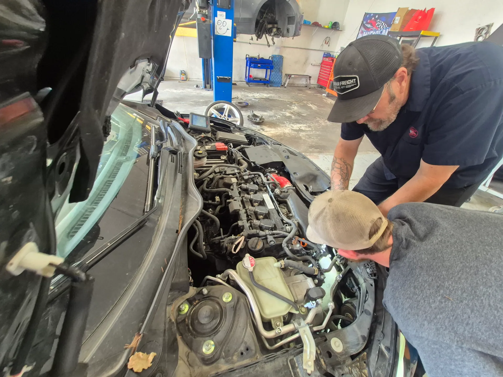 engine diagnostics and repair under open hood