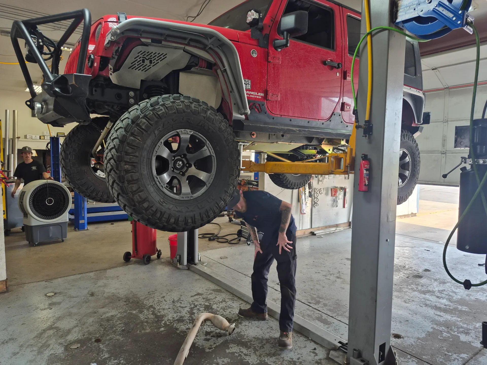 jeep suspension and exhaust inspection on vehicle lift