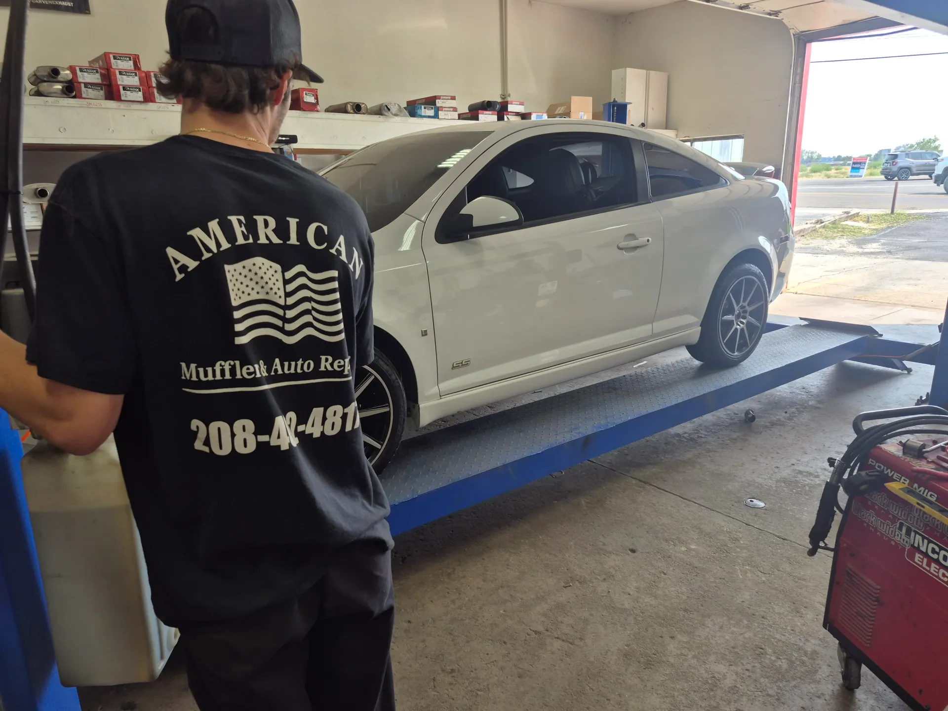 lowering a car on the lift after auto repair