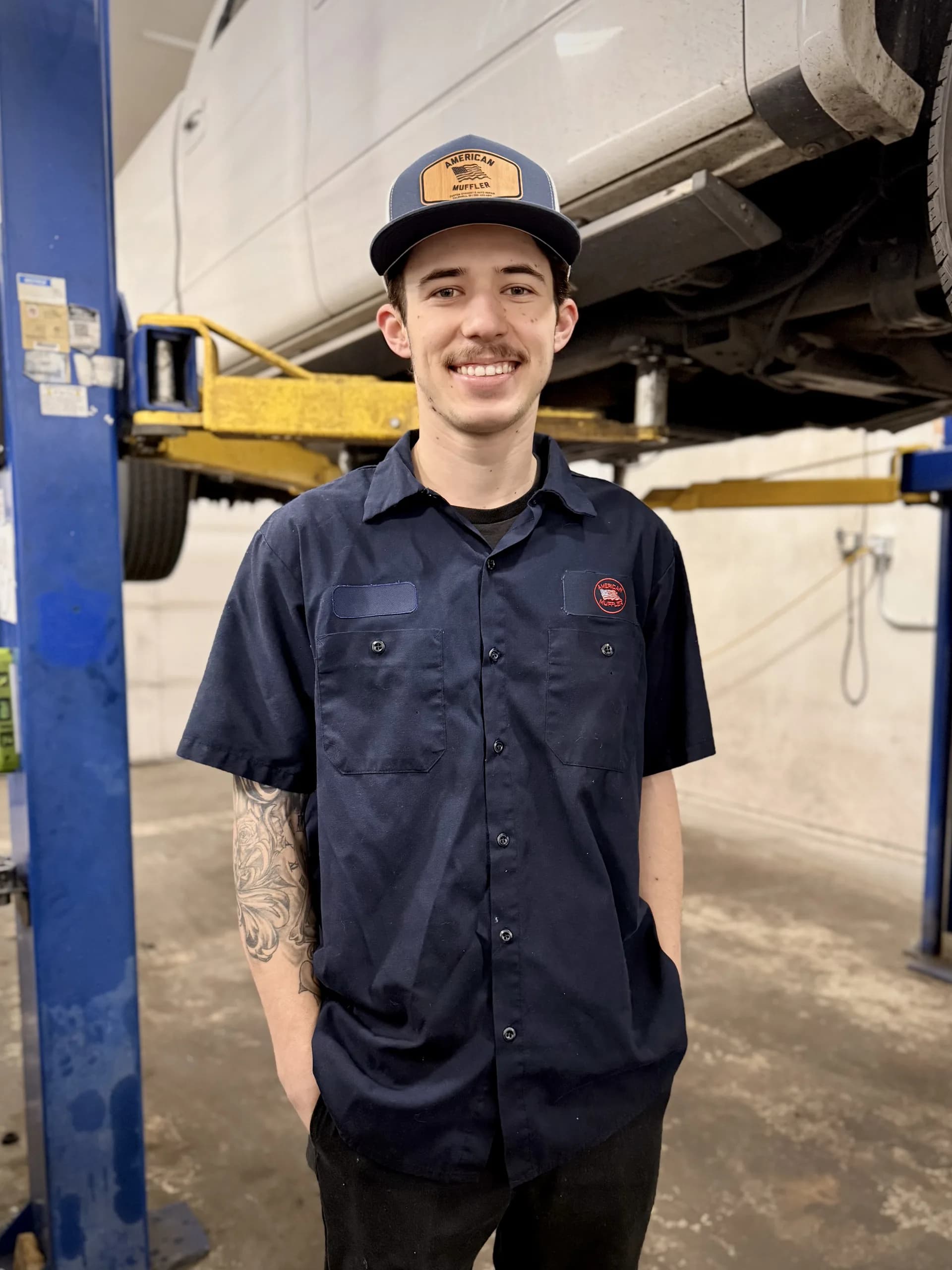 professional mechanic portrait with vehicle on lift
