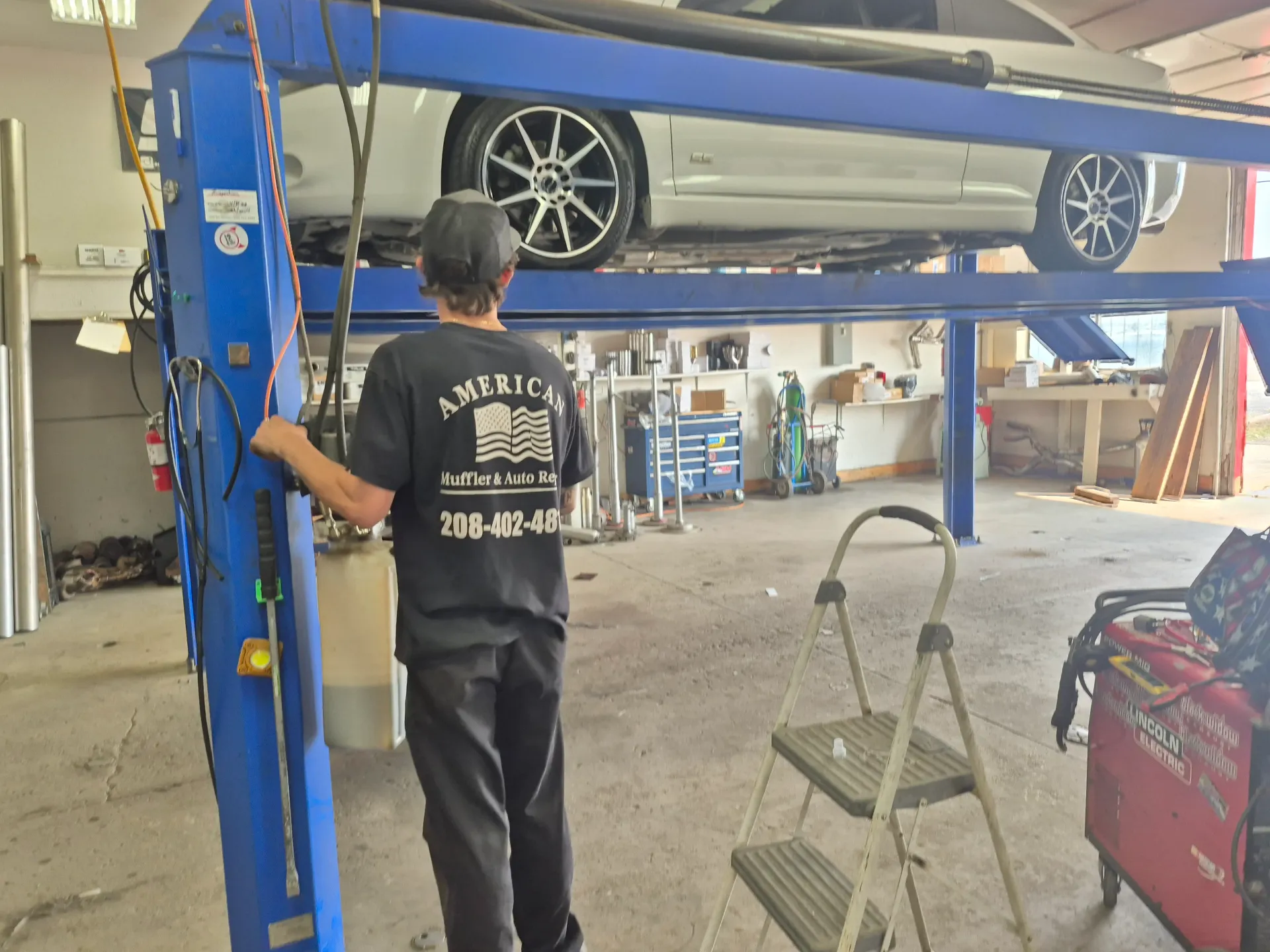 vehicle raised on lift for auto repair and exhaust work